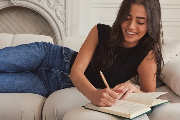 Writing in the journal on the couch